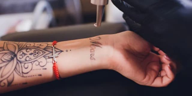 MEDIUM area (size of hand up to a half sheet of paper): SIX laser tattoo removal sessions