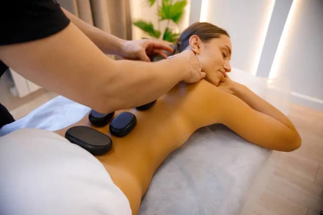50-Minute Hot Stone Massage and 50-Minute Rose Petal Facial with Choice of Microdermabrasion or Face Massage